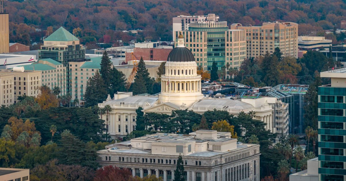 Stunning aerial view of the iconic California State Capitol in Sacramento surrounded by cityscape.